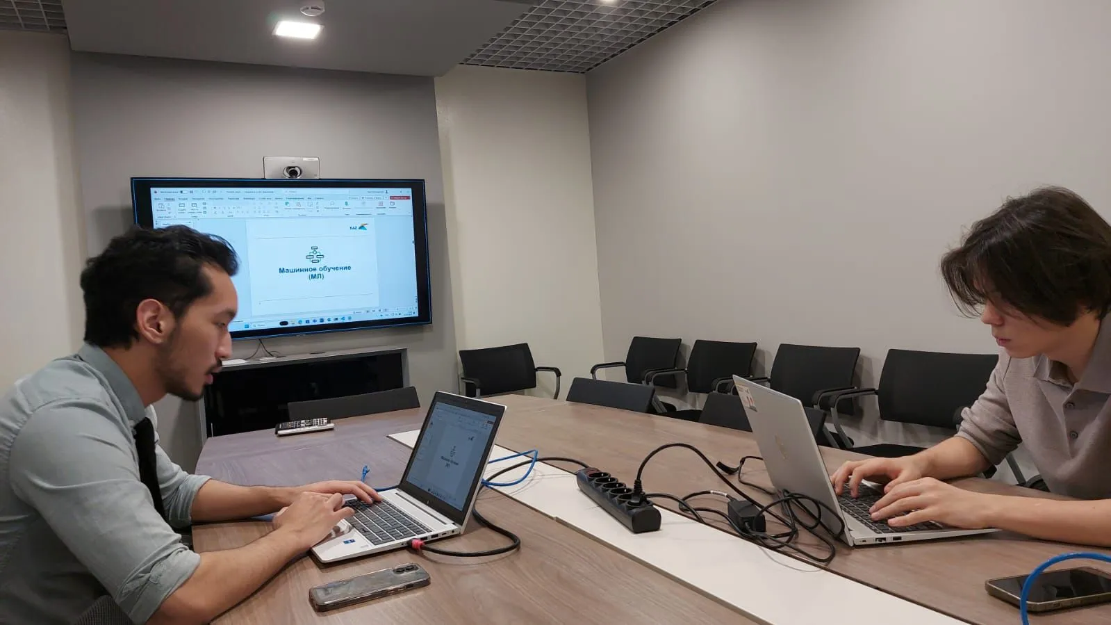 Rakhmetzhanov (right) coding at his machine learning and software engineering internship at KAZ Minerals in 2023.